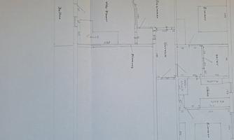 A sketched floor plan of a house with multiple rooms. The dimensions and labels are clearly visible.