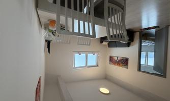 View from the dining area into the bedroom with double bed and the sofa bed