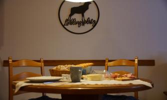 A cozy dining table with a colorful selection of food and drinks. In the background, a decorative sign hangs with the inscription "Favorite Spot".