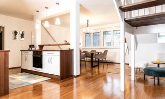 A modern, bright kitchen with wood details and an open living area. The space is well-designed and invites you to linger.