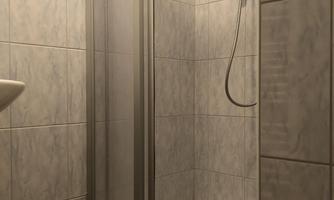 A modern shower with gray tiles and a glass shower partition. The floor is made of wood.