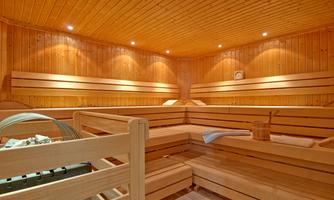 A cozy sauna with wooden paneling and soft lighting. The room offers a relaxed atmosphere for unwinding and feeling good.