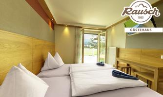 A cozy room with two beds and modern design.  
Large windows provide plenty of light and a view of the outdoors.