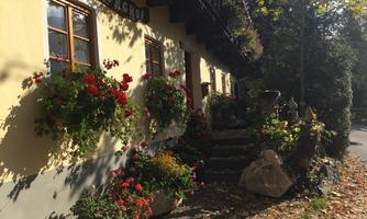 A charming house with colorful flower boxes and an inviting entrance. The autumn makes the surroundings shine in warm colors.