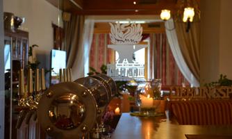 A cozy interior with a bar and elegant furnishings. The atmosphere is inviting and warm.