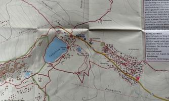 A detailed hiking map with marked trails, lakes, and surrounding descriptions. Red marked points indicate important places and landmarks.