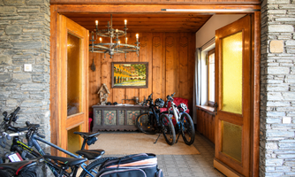 An inviting entrance area with wooden paneling and ample space for your bicycles.
