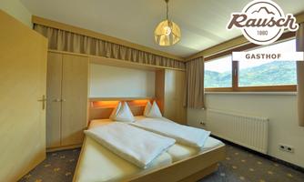 A bright and cozy bedroom with two single beds and a large window that lets in light. The room has a modern wooden interior and a pleasant atmosphere.