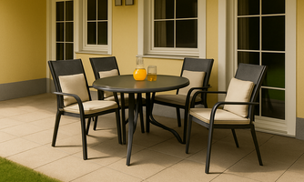A cozy outdoor area with a round table and four chairs. The floor is tiled, and the walls are painted in warm colors.
