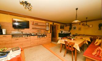A cozy dining area with tables and chairs, surrounded by warm colors.