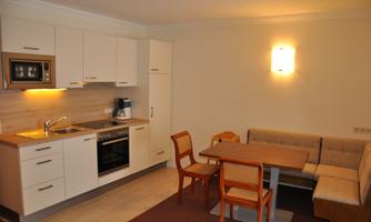 A modern kitchen with a dining area. The decor is bright and inviting.