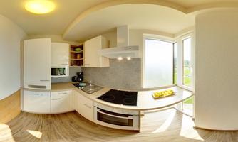 A modern kitchen with white cabinets and a bright, open space. Large windows provide plenty of natural light.