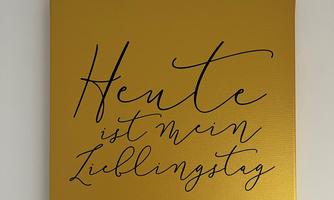 A golden poster with the inscription: "Today is my favorite day." The font is elegant and curvy.