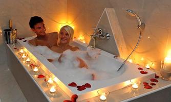 A romantic bath with candlelight and bubble bath. A couple relaxes together in the bathtub, surrounded by rose petals.