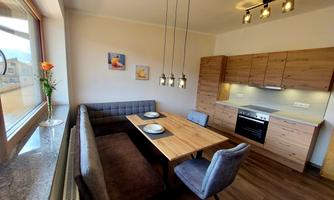 The kitchen with a dining area is fully equipped.  <br/>The room has large windows that let in plenty of light.
