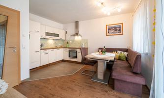 A modern kitchen with a cozy seating area. Bright colors and an inviting ambiance create a friendly atmosphere.
