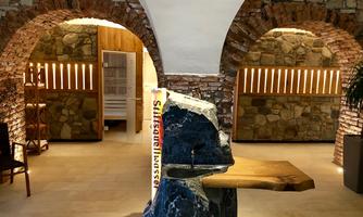 A stylish spa with rustic stone design and modern wooden elements. The entrance area invites relaxation.