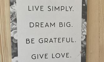 A striking quote on a white background with black-and-white flowers. The message encompasses the themes of simplicity, gratitude, love, and joy.