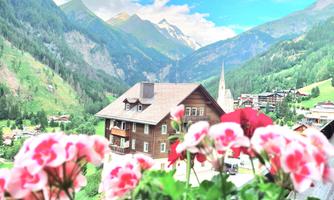 A picturesque mountain landscape with a charming wooden house and colorful flowers in the foreground. Majestic mountains rise above the green valleys under a blue sky.