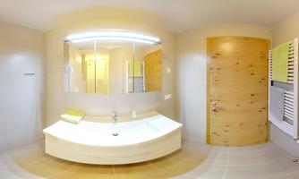 A modern bathroom with a bright sink and a large mirror. The walls are light and the door is made of wood.