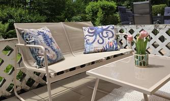 A beautiful outdoor area with a cozy bench and a table.