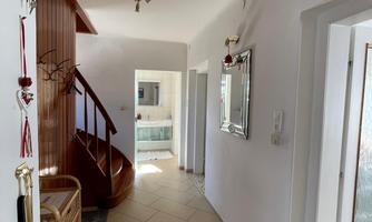 Ante room with rustic wooden staircase and access to bathroom 1, kitchen, and living room