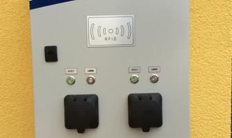 An electric charging station for vehicles. It features two charging ports and various controls.
