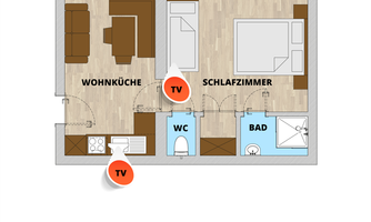 The image shows a floor plan of an apartment with a living area, a kitchen, a bedroom, and bathrooms. Two televisions are indicated in the living area and the bedroom.