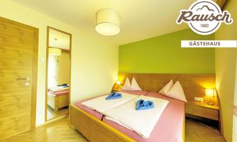 A cozy room with a double bed and two nightstands. The walls are painted in soft colors, and a mirror is visible.