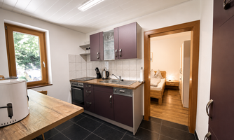 A modern kitchen with ample space and a sideboard. The kitchen is fully equipped, including a dishwasher.