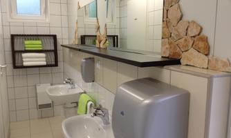 A modern bathroom with two sinks and a large mirror. Fresh towels and a bright, inviting atmosphere.