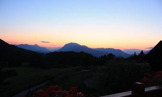 A picturesque sunset over the mountains. The soft colors of the sky reflect in the landscape.