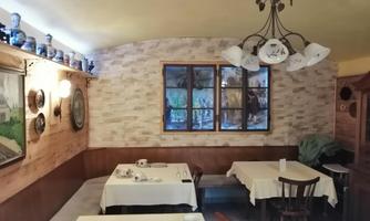 A cozy breakfast room for house guests with set tables and traditional furnishings.