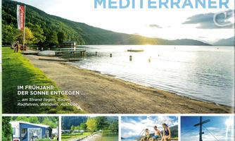 A beautiful lake with a peaceful promenade and floating boats. The surroundings are green and invite relaxation and activities.