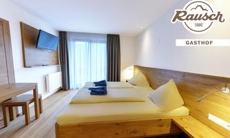A modern room with wooden details and two single beds. Large windows provide plenty of daylight and a cozy atmosphere.