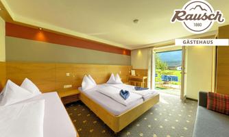 A modern guest room with two beds and a small balcony. The room is bright and cheerfully decorated, with a beautiful view outside.