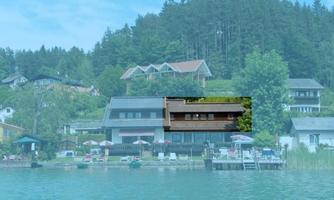 A tranquil lakeside with modern houses and lush vegetation in the background. Umbrellas and sun loungers invite relaxation by the water.