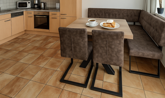 A modern kitchen with a dining table and comfortable seating. On the table are plates with pastries and cups of coffee.