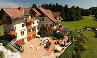 A beautiful house with several balconies and an inviting terrace. The garden is green and provides space for relaxation.