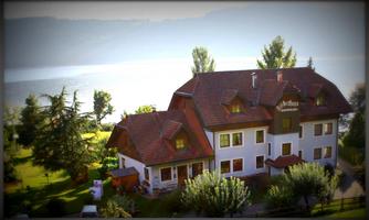 A picturesque house by the shore of a lake, surrounded by trees and a well-maintained garden. The tranquil landscape invites relaxation.