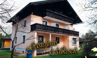A cozy guesthouse with two floors and a balcony. Surrounded by green grass and trees.
