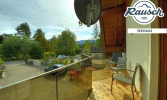 A beautiful balcony with a view of a green garden and trees. The modern furniture invites relaxation.