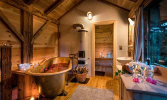 A cozy bathroom with an elegant bathtub and wooden paneling. Soft light and decorations create a relaxing atmosphere.