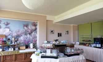 An inviting room with a buffet showcasing various dishes. The walls are decorated with a beautiful floral pattern.
