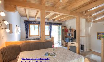 Bright and cozy apartment with wooden ceiling and large windows. There is a dining table and a comfortable sofa for relaxing moments.