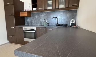 Kitchen area with stove, oven, dishwasher, and cabinets for storage.