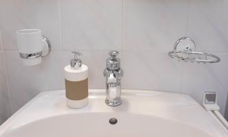 A modern sink with a soap dispenser and a glass holder. Everything is designed in an elegant, minimalist style.