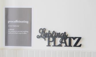 A wall area with a graphic poster and an inscription. The inscription "Favorite PLACE" is in black and stands out from the white wall.