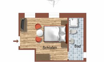 A floor plan of a room with a sleeping area and bathroom. The sleeping area is furnished with a bed, two chairs, and a table.
