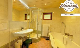 A bright bathroom with a shower and a bathtub. There are modern fixtures and a large mirror.
